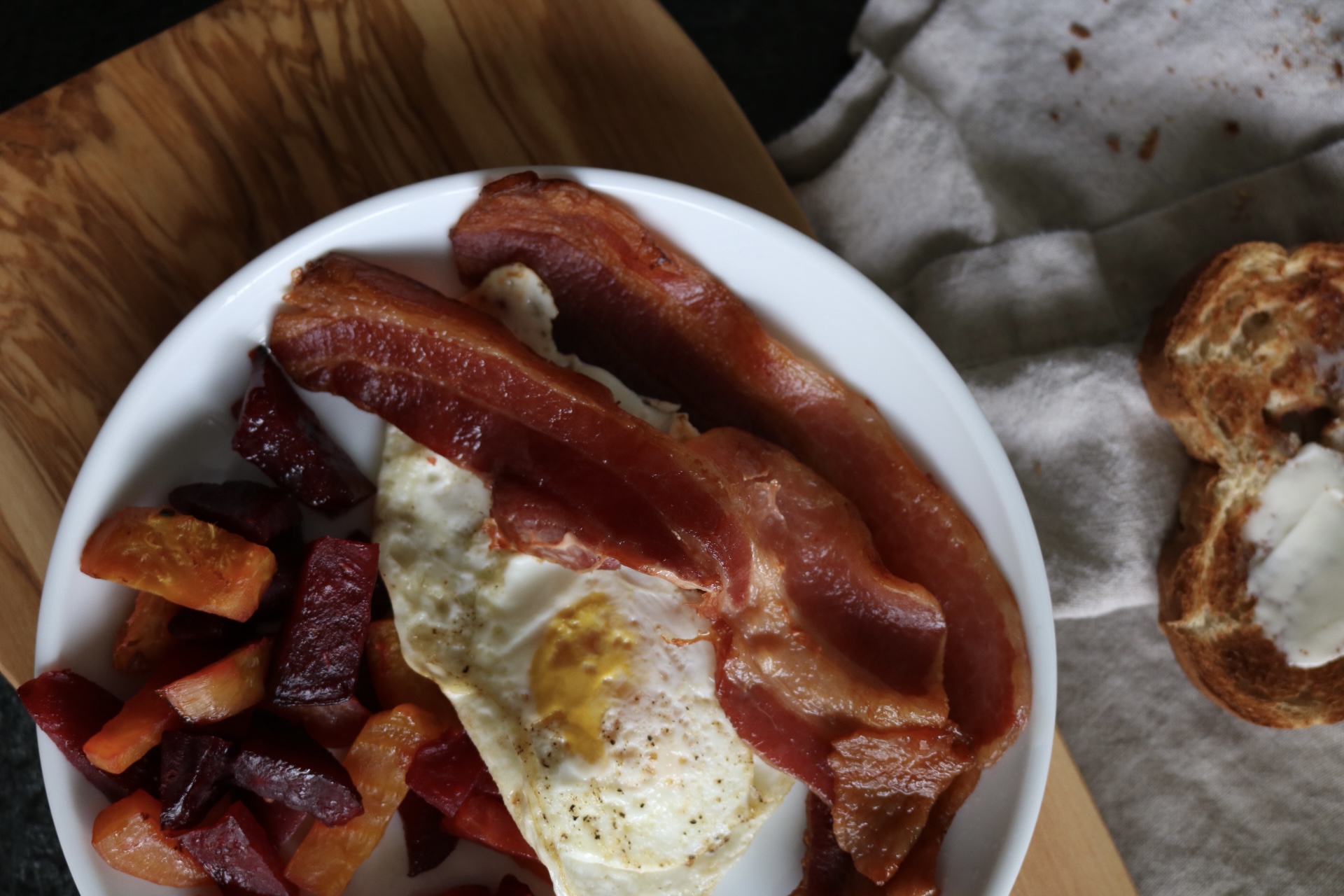 breakfast of beets, bacon, and a fried egg